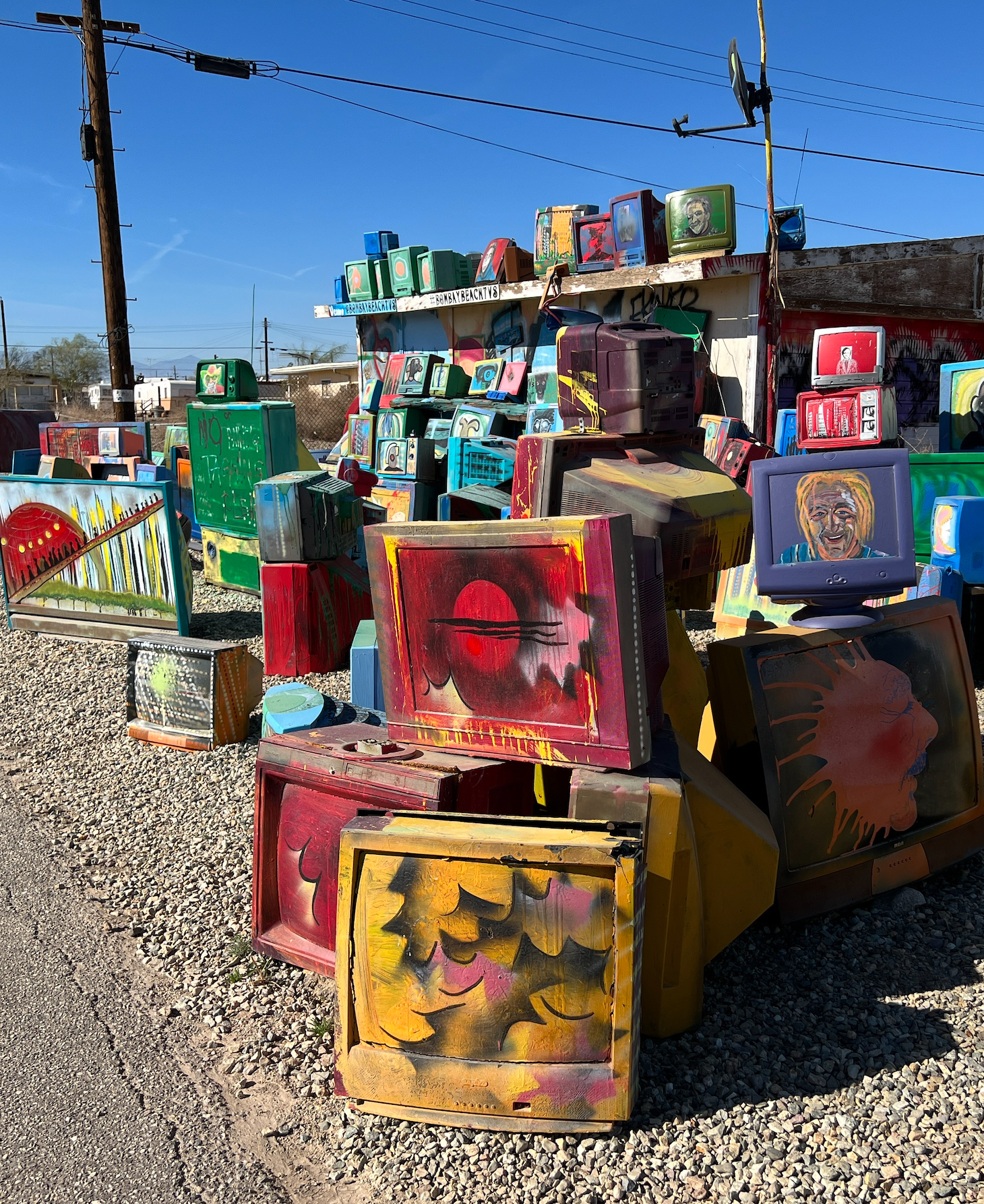 An art display of old television sets painted and organized